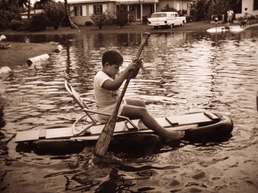 Kid enjoying flooding, c.1960s